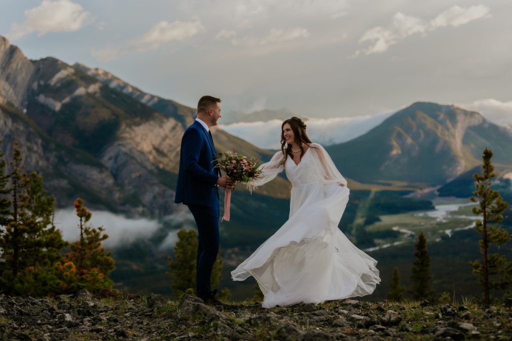 bride and groom dancing in the mountains